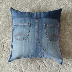 a blue jean pillow on the floor