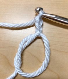 a close up of a piece of white rope with a crochet hook on it