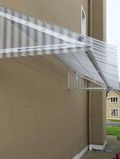 the side of a building with a metal awning over it's door and windows