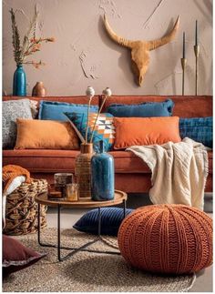 a living room filled with lots of furniture and decor on top of a rug covered floor