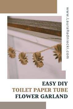 an easy diy toilet paper tube flower garland with leaves hanging from the top and bottom