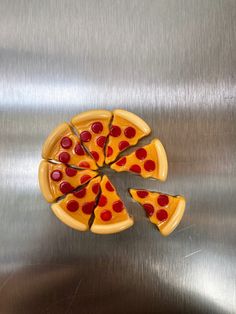 a piece of pizza sitting on top of a metal surface