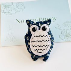 an owl brooch sitting on top of a table