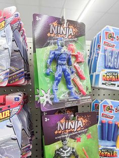 toy action figures are on display for sale in a toys section at a store,