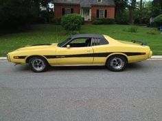 a yellow car parked in front of a house