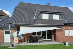 a house with a large white awning over the patio