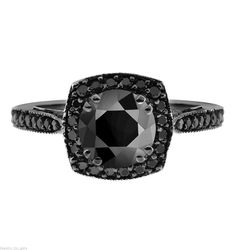 a black diamond ring with white diamonds on the sides and an intricate band around it