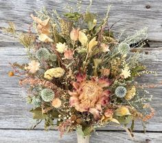 a vase filled with lots of different types of flowers