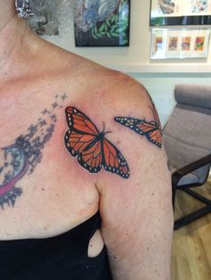 a woman with a butterfly tattoo on her chest