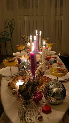 a dinner table with candles and plates on it