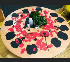 a wooden table topped with lots of cut out hearts