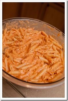 a pan filled with macaroni and cheese on top of a stove