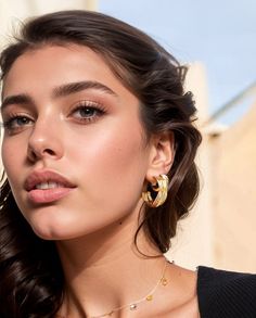 Make a bold statement with the Serenita Gold Hoops, a captivating addition to your jewelry collection. These distinctive earrings feature a layered, nest-like design with exquisite hammered textural details, adding dimension and charm to your ensemble. Handcrafted by talented artisans in Kenya using traditional techniques, each pair is crafted with care from 24k gold-plated brass. The gold plating perfectly matches the brass style in both color and tone, offering a luxurious and lasting touch to Gold-plated Hoop Earrings, Gold-tone Plated Hoop Earrings, Gold Plated Hoop Earrings With Plating Detail, Gold Plated Hoop Earrings With Plating, Yellow Gold Plated Wrap Earrings, Gold Plated Yellow Gold Wrap Earrings, Small Gold-plated Hoop Earrings, Small Hoop Gold Plated Earrings With Plating, Small Hoop Gold Plated Earrings