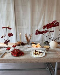 a table topped with lots of food and candles