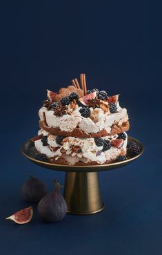 a layered cake with fruit and nuts on top