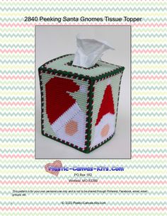 a crocheted tissue box with santa's house on it