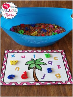 a blue bowl filled with letters and a palm tree