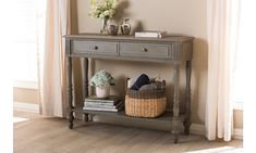 a gray console table with two drawers and baskets on it, in front of a window