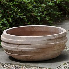 a planter sitting on top of a stone walkway