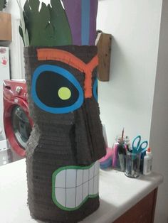 a paper mache made to look like a tiki mask on a counter top