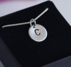 Initial necklace Sterling silver charm  Sterling silver jump ring Sterling silver chain Supplied in a carboard box 5 x 5 cm The size of the charm is 12 mm, hammered, polished and treated with wax to prevent tarnishing.  Some small imperfections still can be seen under magnification The width of the chain is 1.7 mm Please add a note at checkout with your preffered initial  Shipped within 2 days Thank you for visiting my shop Sterling Silver Initial Necklace, Silver Initial Necklace, Initial Necklace Silver, Sterling Silver Initial, Sterling Silver Charm, Necklace Silver, Initial Necklace, Sterling Silber, Sterling Silver Chains