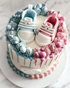 there is a cake decorated with baby shoes