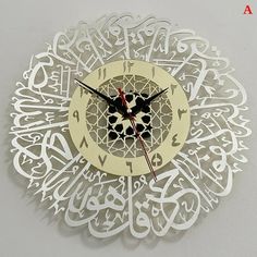 an intricate clock with arabic writing on the face and hands is featured in this image