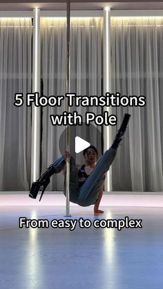 a woman is sitting on the floor with pole