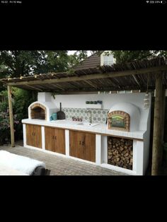 an outdoor kitchen with wood and tile counter tops