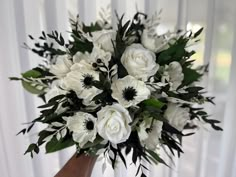 a bouquet of white flowers sitting on top of a table