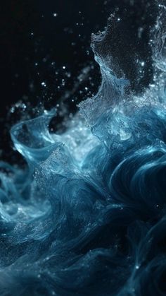 the water is splashing on top of the waves in the dark blue ocean with white bubbles