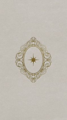 an image of a star in the middle of a white paper with gold foil on it