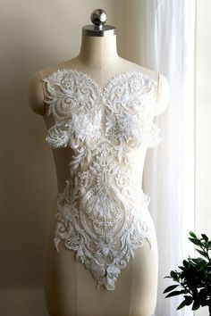 Luxurious LIGHT IVORY Heavy Beaded Lace Applique, Made with RAYON. Perfect for bringing BEAUTY to your Wedding Gowns, Bridal Veils, Lace Garters, Ballet, Elegant Dresses, or other Costume Designs! 💡 Similar item: https://www.etsy.com/shop/LaceLoveLife?search_query=a072 Quantity: for 1 piece Size: about 25" X 12" (62cm X 30cm) Shipping: USPS first class. Message for details if rush order is needed. BRIDAL LACE APPLIQUES:  https://www.etsy.com/shop/LaceLoveLife?section_id=26002301 BRIDAL LACE TRI White Lace Bodice With Sweetheart Neckline, White Sleeveless Lace Bodice, Embellished White Wedding Dress For Wedding Night, Fitted White Bridal Accessories With Pearl Embroidery, White Beaded Lace Bridal Accessories, White Embellished Lace For Wedding, Lace Applique Wedding Dress, Bridal Lace Fabric, Embroidered Bodice