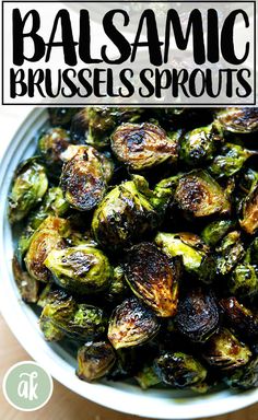 a white bowl filled with brussel sprouts on top of a wooden table