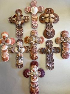 a cross made out of seashells on a wall