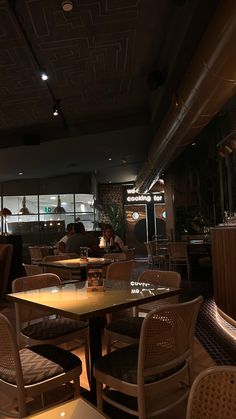 an empty restaurant with many chairs and tables