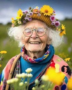 an old woman with glasses and a flower crown on her head standing in a field full of wildflowers