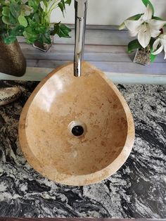 a bathroom sink sitting on top of a marble counter