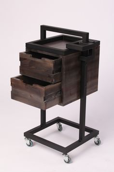 a wooden cart with drawers on wheels and one drawer open to show the bottom section