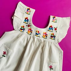 Add a beautiful embroidered piece from Mexico to your child's wardrobe that is handmade, with love. This dress is timeless, and is one-of-a-kind and characterized by it's beautiful and subtle embroidery. These are NOT machine-made knockoffs made in China. DIMENSIONS: Size 2-3 years old = Width: 13 inches across chest Length: 23 inches from shoulder to bottom Arm openings: 7 inches Size 3-4 years old = Width: 14 inches across chest Length: 24 inches from shoulder to bottom Arm openings: 8 inches Subtle Embroidery, Child Dress, Abstract Embroidery, Baby Dress Patterns, Animal Embroidery, Antique Fabrics, Personalized Embroidery, Embroidery Craft