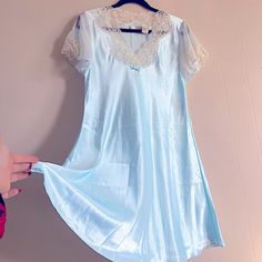 Vintage Intimate Essentials Baby Blue Satin Baby Doll Dress With Delicate Lace Detailing. Nwt In New With Tags Condition. Super Lightweight Satin Material. Reference All Images And Measurements Before Purchase. Feel Free To Ask For Additional If Needed. No Returns. Approx. Measurements Taken From Seam To Seam While The Garment Is Lying Flat. Chest: 19” Waist: 18” Length: 35.5” Smoke Free Home. I’m Open To All Reasonable Offers. Please Use The Send Offer Button Or Click “Buy Now!” No Returns. Bun Blue Nightgown For Wedding Night In Summer, Light Blue Short Sleeve Sleep Dress, Blue Short Sleeve Nightgown For Bedtime, Blue Lace Nightgown With Lace Trim, Light Blue Lace Trim Sleep Dress, Blue Lace Trim Nightgown For Pajama Party, Blue Lace Nightgown For Loungewear, Blue Lace Nightgown For Sleep, Blue V-neck Sleepwear With Lace Trim