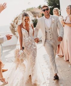 a newly married couple walking down the aisle with confetti thrown in the air