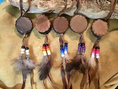 several native american dream catchers with feathers and beads