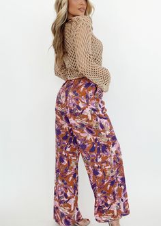 Experience the beauty and vibrance of the tropics with our Ibiza Moonlight Pants. The bold floral print adds a pop of color to your wardrobe, while the high waisted and straight leg design provide a flattering silhouette. Perfect for any occasion, from resort dinners to drinks with friends, these pants offer both comfort and style. Featuring pocket details, stretchy elastic waistband, and an adjustable drawstring, they are as versatile as they are trendy. So whether you're on vacation or simply Summer Multicolor Floral Wide Leg Pants, Bohemian Tropical Print Bottoms For Spring, Bohemian Bottoms With Tropical Print For Spring, Floral Print Wide Leg Pants For Vacation In Spring, Floral Wide Leg Pants For Vacation In Spring, Chic Summer Floral Print Wide Leg Pants, Summer Floral Print Wide-leg Bottoms, Chic Summer Wide Leg Pants With Floral Print, Chic Floral Print Wide Leg Pants For Summer