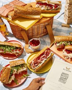 a table with sandwiches and drinks on it