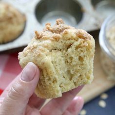 a person holding up a muffin in their hand