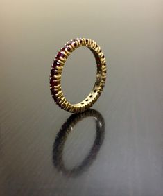 DeKara Designs Collection Beautiful Art Deco Influenced Handmade Ruby Eternity Band. This piece is handmade to perfection, from the stone setting to the finish. High end band, for an affordable price. The rubies are matched as best as possible. Metal- 14K Yellow Gold, .583. Stones- 22-36 Round Rubies, 1.60-2.4 Carats. Number of Sapphires and Carat Weight Depending on your size. Please allow 5-7 working days for us to ship out your band, sometimes sooner. Band will be made as soon as transaction Ruby Eternity Band, Ruby Wedding Band, Ruby Bands, Ruby Wedding, Engagement Band, Gold Art Deco, Stone Setting, Engagement Bands, Gold Art