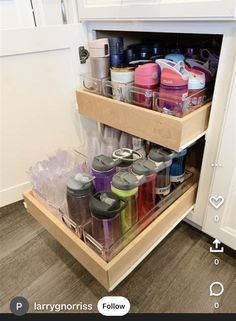 an open cabinet filled with lots of different containers and containers on top of each other