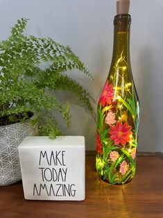 a bottle that is sitting on a table next to a box with some lights in it