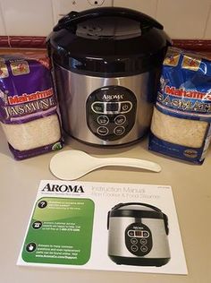 an instant pot and two bags of rice are on the counter next to it's contents